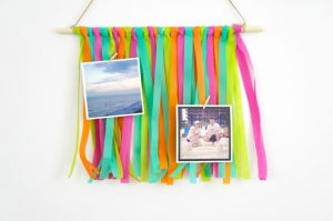 Create your own colorful, on-trend wall hanging using strips of Oly*Fun. This simple project is quick and easy to make, and is a fun way to freshen up your decor for summer. It even becomes a unique way to display photos and mementos, making it a great DIY for dorm rooms!